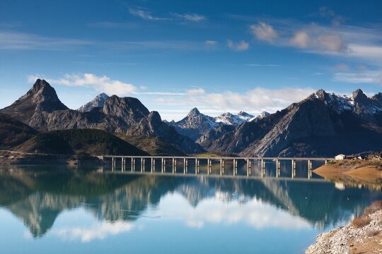 Scenic landscape of a mountains range, Gilbo peak reflection on   a water reservoir in Riano, Spain