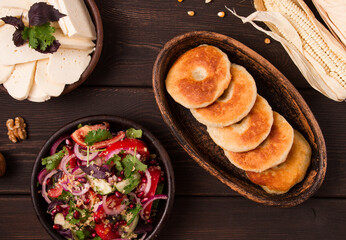 Mchadi, corn tortillas, traditional Georgian dish, corn bread, with Imeretian cheese, homemade, no people, on a wooden table,