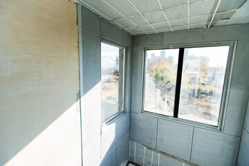 Fototapeta premium A fragment of an unfinished building with a large gray facing tile. Inside view. Close up