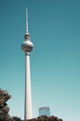 Naklejka premium Vertical low angle of the Berlin television tower against a blue sky