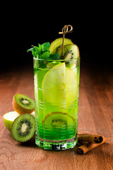 kiwi cocktail lemonade in a dark bar, Fresh kiwi cocktail with mint. Summer cold drink and cocktail
