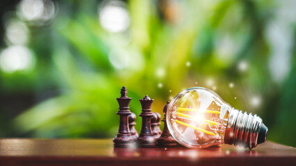 a light bulb shining beside a chess Means having a good strategy for doing business.