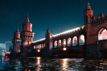 Scenic view of Oberbaum Bridge in Berlin, Germany with a starry night in the background