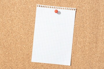 Blank grid paper sheet pinned on cork board