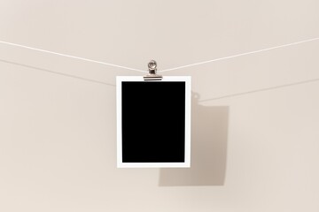 Blank Vintage instant photo frame hanging on a rope