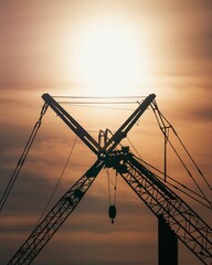 Vertical shot of a power transmission during the sunset