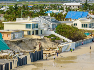 People looking at homes washed away by Hurricane Nicole Daytona Beach FL