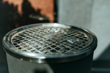 Closeup of the ashtray of a trash can