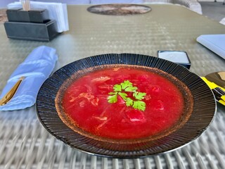 Ukrainian borscht in a black plate