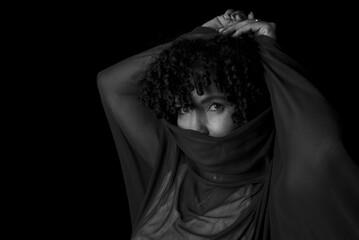 Close-up black and white portrait of woman with transparent cloth