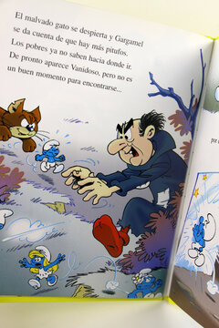 The Smurfs storybook. The wizard Gargamel and his cat Azrael in his castle. Gargamel making potions to catch the Smurfs. Characters created by Peyo. TV series. Book for children.