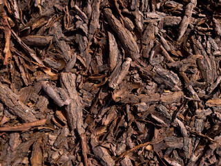 Brown mulch made of pine bark. Fertilizer for agriculture.