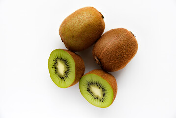 Fototapeta premium Chopped fruit of green juicy kiwi on a white background. Delicious kiwi slices close-up.