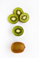 Obraz premium Chopped fruit of green juicy kiwi on a white background. Delicious kiwi slices close-up.