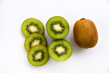 Chopped fruit of green juicy kiwi on a white background. Delicious kiwi slices close-up.