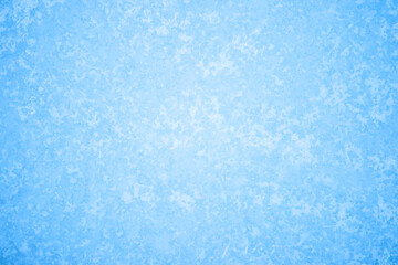 The blue texture of ice in the glow of a pattern of white frost. Background concept