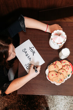 Little Girl Leaving Cookies And Glass Of Milk For Santa, Writing A Card