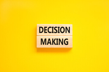 Decision making symbol. Concept words Decision making on wooden blocks. Beautiful yellow table yellow background. Business and decision making concept. Copy space.