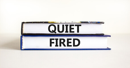 Quiet fired symbol. Concept words Quiet fired on books. Beautiful white table white background. Business and quiet fired concept. Copy space.