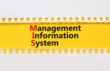 MIS management information system symbol. Concept words MIS management information system on yellow paper on beautiful white background. Business MIS management information system concept. Copy space © Dzmitry