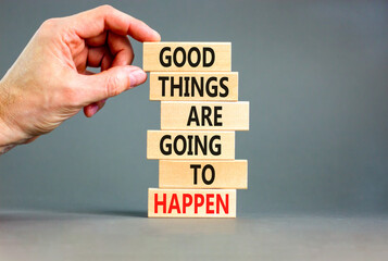 Good things happen symbol. Concept words Good things are going to happen on wooden blocks on a beautiful grey table grey background. Businessman hand. Business good things happen concept.