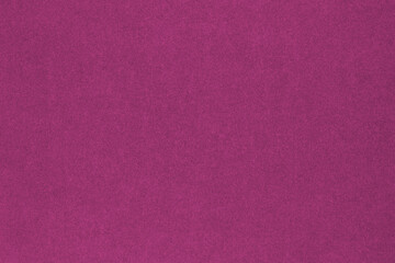 Dark pink colored paper texture. Tinted background. Textured wallpaper. Finely patterned surface....