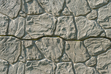 Concrete decorative fence from panels. A panel fence with a natural stone-like texture. Solid background