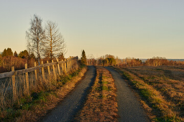 Fototapeta premium A short evening walk on a gravel road below Skreia, Toten, Norway, in November.