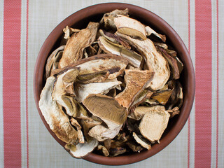 Dry mushrooms (Boletus edulis) on the table, top view. Gourmet dishes of porcini mushrooms.