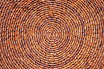 Round-weaved straw mat texture with concentric circles. Spiral background