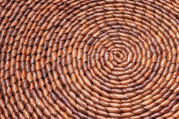 Concentric circles of a straw decorative placemat. Natural table mat, full frame background