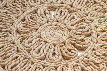 Closeup shot of round woven decorative placemat. Table pad background