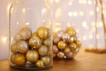 Close-up of golden glittery decorative Christmas glitters inside transparent glass jar
