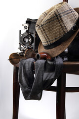Retro photo camera, hat and glasses on a round chair