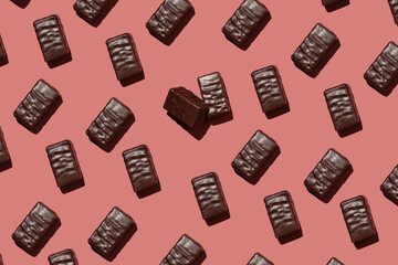 pattern with chocolates on a pink background