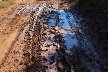 Mud and puddles on the dirt road