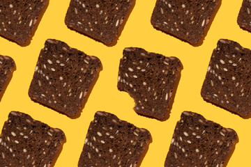 black bread with seeds pattern on yellow background