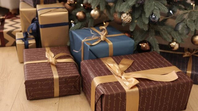 Preparation for holidays, New Year gift, Christmas tree. Many Christmas gift boxes are tied together with ribbons and decorations, a Christmas background is seen, beautiful Christmas gift boxes