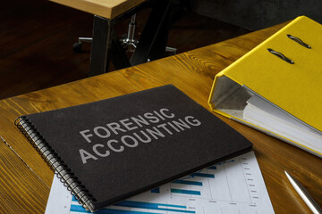 Notepad with phrase forensic accounting, folder and papers.