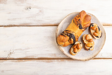 Fototapeta na wymiar Homemade sweet bun with honey almonds on a white. top view, copy space.