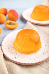Apricot orange jelly on blue. side view, selective focus.