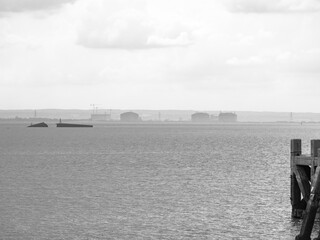 Layered view of industrial coastline with remains in water