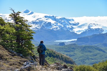 Fototapeta na wymiar hiker enjoying view of andes mountains glaciers and lakes at Torres del Paine national park, Chile