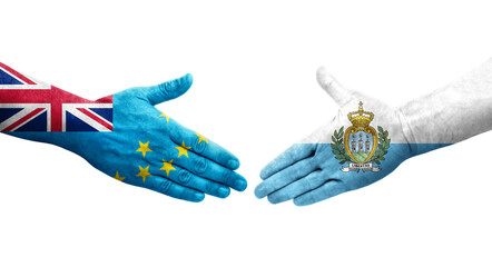 Handshake between Tuvalu and San Marino flags painted on hands, isolated transparent image.