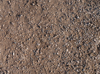 Background, top view. Sand and gravel on a country road. Golden sand and small smooth pebbles on the road. concept background sand and gravel.