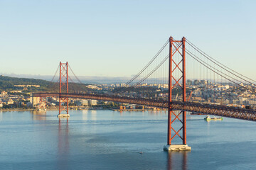 Fototapeta na wymiar Red Bridge April 25th in Lisbon in the morning sun