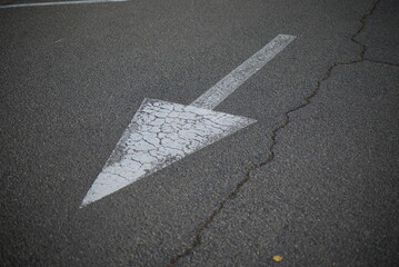 white arrow straight ahead direction of movement, direction of movement to the right, direction arrow for parking, white arrow on gray asphalt, asphalt texture, pedestrian crossing symmetrical