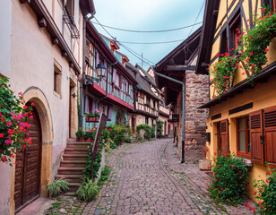 Fototapeta na wymiar Eguisheim, France - October 12, 2022: Traditional medieval houses in Eguisheim in Alsace along the wine road