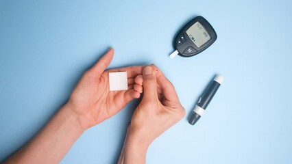 A woman measures the level of glucose in the blood with a glucometer. glucose value 4.7. Blood glucose level is normal. International Diabetes Awareness Day