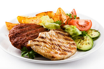 Grilled steaks, baked potatoes and vegetable salad